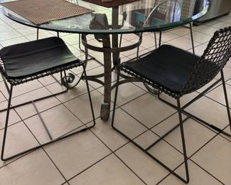 GLASS TOP ROUND KITCHEN TABLE WITH FOUR BLACK WIRE CHAIRS