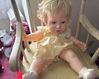 Lot 157: Vintage baby doll on a wooden rocking chair