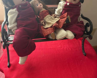 Lot 141: Three cloth dolls on a bench