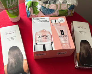 Lot 153: Clinique moisture surge gift set with hair care and foot scrub