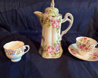 Lot 202: Nippon Floral porcelain teapot with lid and two teacups with saucers