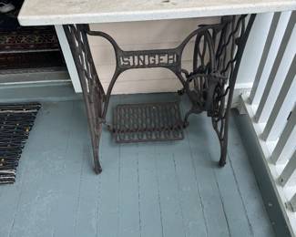 one of three marble top tables made from Singer sewing machines