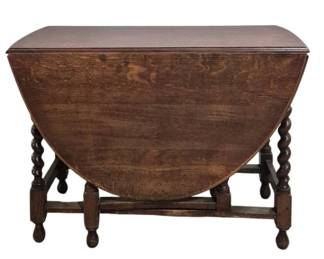 1420 - English Barley Twist Oak Gate Leg Table (Description): English barley twist gate leg table featuring  traditional craftsmanship. The table  measures 28.5 inches tall by 41 inches wide  by 19 inches deep when closed, extending to  58 inches when fully open.