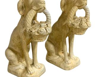 7717 - Pr Polyresin Dog Statues w/ Flower Baskets (Description): Pair of polyresin dog statues depicting  seated dogs holding flower baskets in their  mouths. Each figure features a dog with a  twisted rope handle basket filled with roses.  The statues have a cream-colored finish with an aged, speckled patina giving them a  weathered garden statue appearance. Measuring  25 inches tall by 14 inches wide by 8 inches  deep.