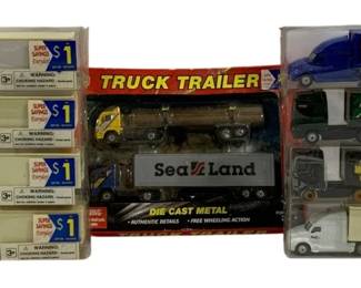 1023 - 9pc Lot Semi-Truck Tractor Trailers (Description): A collection of nine semi-truck tractor  trailers. The lot includes various die cast  metal truck and trailer models in their  original packaging.