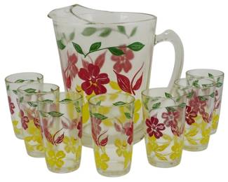 876 - Vtg Floral Glass Pitcher and 7 Tumblers Set (Description): Featuring a colorful floral pattern. The  clear glass pieces are decorated with red,  yellow, and pink flowers accented by green  leaves in a cheerful mid-century style  design. The set includes one pitcher with an applied handle and ice lip, accompanied by  seven matching drinking glasses.