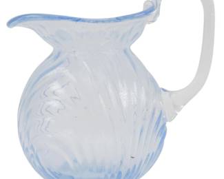 752 - Reproduction Cambridge Child's Pitcher 4.5" (Description): Reproduction Cambridge child's pitcher in  pale blue Caprice pattern glass featuring a  swirled ribbed pattern on the body. The  pitcher has a rounded bulbous form with a  flared spout and applied handle. Measures 4.5 inches in height.