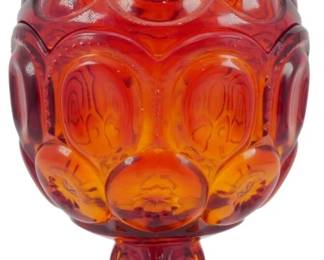 996 - Vtg L.E. Smith Amberina Glass Candy Dish (Description): Vintage L.E. Smith amberina glass candy dish  featuring the iconic Moon and Stars pattern.  This footed compote-style dish has a lidded  design with a decorative finial. The glass  transitions from a deep ruby red at the top through amber tones to a golden yellow at the  scalloped base. Measures 8 inches tall by  4.5 inches in diameter.