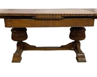 7791 - Oak Carved Trestle Dining Table w/ Leaves (Description): Oak trestle dining table with leaves. The  table features a burl wood top with inlaid  banding along the edges and clipped corners.  It rests on a double pedestal trestle base  with carved bulbous supports, fluted details, and stepped block feet connected by a  stretcher. Measures 30 inches high by 84  inches long by 45 inches wide.