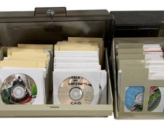 1052 - 2 pc. CD Holders w/ Assorted Discs (Description): Two piece CD holders with assorted discs. The  set includes storage cases containing  various CDs and DVDs.