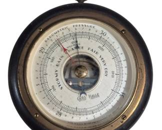 1428 - Carl Halle Barometer 5.5" (Description): Carl Halle barometer featuring a round face  with barometric pressure readings in inches  and millibars, with weather condition  indicators ranging from Stormy to Very Dry.  The instrument has a brass-toned metal bezel set in a dark wood frame with a hanging ring  at top. Made in U.S.A. Measures 5.5" in  diameter. Used as is  electric/electronic/mechanical item. No  guarantee all components present, untested.