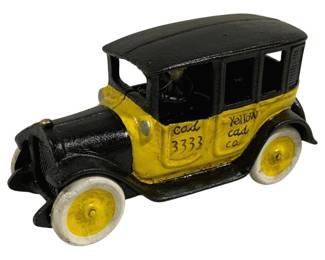 1517 - Cast Iron Yellow Cab Co. Taxi Toy (Description): Cast iron toy taxi painted in classic yellow  and black livery, featuring "Yellow Cab Co."  and "Cab 3333" markings on the body. The  vintage-style sedan includes a cast driver  figure and white rubber tires with yellow centers. Measures 9" x 3.5"".