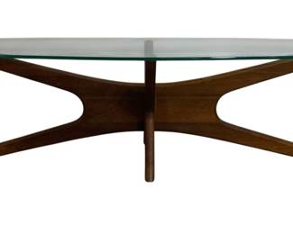 7626 - Adrian Pearsall Mid-Century Jacks Coffee Table (Description): Featuring an oval clear glass top supported  by a sculptural walnut base. The base  displays the characteristic jacks or  starburst design popular in 1950s-60s Danish  modern furniture, with elegant curved supports meeting at a central point. Measures  16 inches high by 54 inches wide by 20  inches deep.