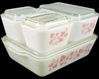 1234 - Pyrex Gooseberry 4pc Refrigerator Set Pink (Description): Pyrex Gooseberry 4-piece refrigerator set in  pink. This vintage set features the classic  pink Gooseberry pattern on white milk glass,  consisting of one large rectangular dish and  three smaller refrigerator dishes, all with clear glass lids. The distinctive mid-century  pattern showcases pink gooseberries and  leaves against the white opal glass  background.