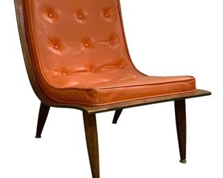 7607 - Carter Bros MCM Orange Scoop Lounge Chair (Description): Featuring a sculptural walnut frame with  tapered legs and brass ferrules. The chair is  upholstered in burnt orange tufted vinyl  with button detailing on both the seat and  back cushions. Measures 29 inches high by 22 inches wide by 27 inches deep.