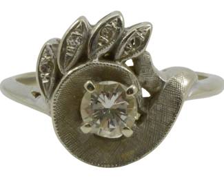 821 - 14K White Gold Diamond Ring Size 5.5 0.12oz (Description): 14K white gold ring featuring a prong-set  round brilliant cut diamond as the center  stone. The design incorporates a stylized  floral or leaf motif with five  marquise-shaped accents, each set with a small diamond chip. The band displays a  Florentine textured finish on the face. Ring  size 5.5, weighing 0.12oz.
