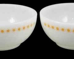 1139 - Set of 4 Fire King Orange Starburst Bowls (Description): Set of four Fire King milk glass bowls  featuring the Orange Starburst pattern. Each  bowl displays a decorative band of orange and  gold sunburst motifs around the exterior  rim. The bowls are in the classic cereal or soup bowl shape with a clean whiteinterior.  Measurements: 2" x 5".