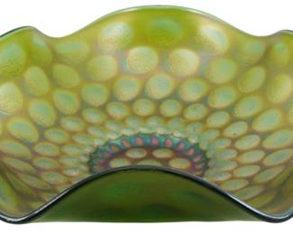 676 - Fenton Emerald Green Coin Dot Carnival Bowl (Description): Vintage Fenton emerald green Coin Dot  carnival glass bowl featuring an iridescent  finish with a distinctive raised dot pattern  radiating from the center. The bowl has a  scalloped, ruffled rim with six lobes and displays beautiful multicolored iridescence  including purple and gold tones at the  center. Measures 3 inches tall by 9 inches in  diameter.