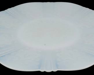930 - Monax American Sweetheart Platter (Description): Monax American Sweetheart platter in the  classic opalescent white milk glass. This  Depression-era piece features the distinctive  scalloped edge and elegant embossed scroll  and floral center design characteristic of the American Sweetheart pattern produced by  Macbeth-Evans Glass Company.
