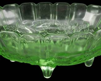 1242 - Vtg Indiana Harvest Grape Uranium Glass Bowl (Description): Vintage Indiana Harvest Grape uranium  depression glass bowl featuring a scalloped  rim and decorative grape and leaf pattern.  This footed bowl displays the characteristic  green glow of uranium glass. Measures 4.5 inches tall by 12 inches long by 8 inches  wide.