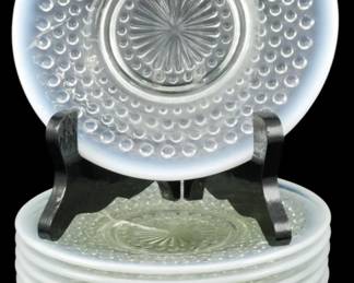 921 - 11 Anchor Hocking Moonstone Opalescent Dishes (Description): Set of eleven vintage Anchor Hocking  Moonstone pattern dishes featuring the  distinctive hobnail design with opalescent  white edges and clear centers with a  starburst motif. These classic Depression-era glass pieces showcase the signature milky  white rim characteristic of the Moonstone  pattern. Each dish measures 6.5 inches in  diameter.