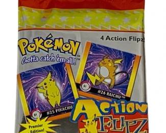 1546 - Pokemon Action Flipz Card Pack (Description): Pokemon Action Flipz card pack by Harding,  Premier Edition. This sealed pack contains 4  Action Flipz lenticular action collectibles  featuring Pikachu and Raichu artwork on the  packaging. The pack displays the classic 'Gotta catch 'em all!' tagline.