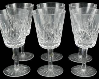 912 - 6 Waterford Crystal Lismore Stems 7" (Description): Set of six Waterford Crystal stemware glasses  in the classic Lismore pattern. Each goblet  features the signature diamond and wedge cut  design on the bowl with a faceted stem and  starburst cut base. These elegant water or wine glasses stand 7 inchestall and bear the  distinctive brilliance and clarity  characteristic of Waterford Irish crystal.