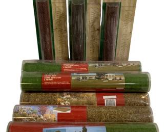 1053 - Lemax Village Collection Landscape Mats Lot (Description): Lot of Lemax Village Collection landscape  accessories including grass mats and  decorative landscape accent rolls. Items  appear to be in original packaging and are  suitable for creating miniature village displays and dioramas.