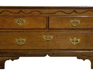 7732 - Antique English Oak 3 Drawer Chest (Description): A handsome antique English oak three drawer  chest featuring two small drawers over one  long drawer. The piece displays elegant  decorative brass bail pulls with ornate back  plates and a shaped apron with bracket feet. The chest exhibits a lovely warm patina  consistent with age and quality craftsmanship  in the Georgian style.