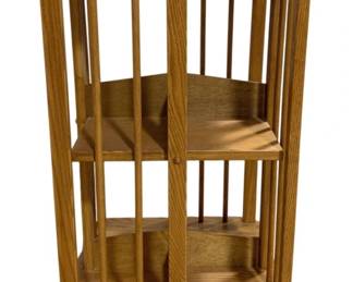 7787 - English Oak Revolving Bookcase 29"x18"x18" (Description): Oak rotating bookcase featuring a spindle  design with vertical dowels surrounding three  tiers of shelving. The piece has a warm  honey-toned finish and sits on a sturdy base  that allows for 360-degree rotation. The bookcase measures 29 inches tall by18 inches  wide by 18 inches deep.