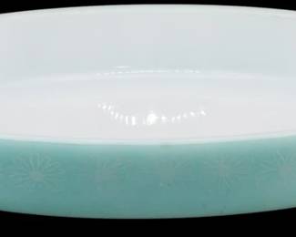 1159 - Pyrex Turquoise Daisy Oval Casserole (Description): Pyrex turquoise daisy oval casserole dish  featuring the classic mid-century pattern  with white daisy motifs on a soft turquoise  exterior and white interior. The dish has  distinctive tab handles on each end. Measures 1.5 inches tall by 11 inches longby 7 inches  wide.
