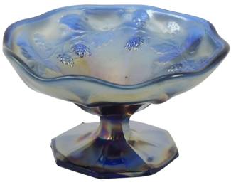 693 - Vtg Fenton Cobalt Blue Blackberry Carnival (Description): Vintage Fenton cobalt blue Blackberry pattern  carnival glass mini compote. This charming  piece features the classic Blackberry motif  with raised grape and leaf designs around the  scalloped rim. The iridescent carnival glass finish displays beautiful blue and amber  tones. The compote sits on an octagonal  pedestal base. Measures 2 1/2 inches tall by  4 inches in diameter.