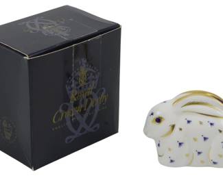 806 - Royal Crown Derby Baby Rabbit Paperweight (Description): Royal Crown Derby baby rabbit paperweight  featuring the classic Imari-style decoration  in cobalt blue and gold on a white bone china  body. The piece has a gold stopper,  indicating it is a first-quality piece. Comes with original presentation box. Measures 2  inches.