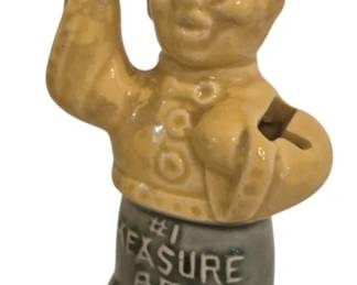 2779 - Ceramic Measure Boy Figurine (Description): In the form of a smiling boy with  outstretched arms. Features a yellow glazed  upper body with textured detailing and a gray  glazed lower portion marked "Measure Boy."  The charming folk-style figure functions as resting stands for measuring spoons.