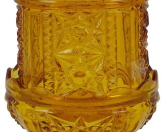 871 - Indiana Glass Stars & Bars Amber Lamp (Description): Vintage Indiana Glass Stars & Bars pattern  fairy lamp in amber glass. This two-piece  pressed glass fairy lamp features the classic  geometric Stars & Bars design with a domed  shade that rests on a footed base. The rich golden amber coloring shows beautiful  transparency when illuminated. Measures 7  inches tall.