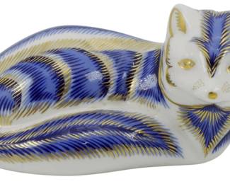 803 - Royal Crown Derby Arctic Fox Paperweight (Description): Royal Crown Derby Arctic Fox paperweight  featuring the brand's signature Imari-style  decoration in cobalt blue and gold on white  porcelain. The reclining fox displays  intricate hand-painted feathered patterns across its body with gold accent details.  Fitted with a silver stopper on the base.  Measures 2 inches.