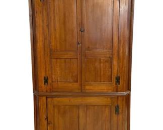 7681 - Antique Pine Corner Cupboard 42"x22"x26" (Description): Antique pine corner cupboard featuring a  two-piece construction with upper and lower  cabinet sections. The upper portion has  double paneled doors with iron H-hinges and a  molded cornice top. The lower section features a single paneled door, also with  iron H-hinges. The warm honey-toned wood  finish shows beautiful natural patina  consistent with age. This traditional  American country style piece measures 42