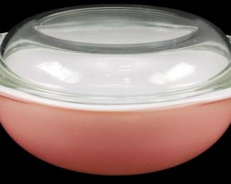 1105 - Pyrex Flamingo Pink Casserole Dish w/ Lid (Description): Vintage Pyrex Flamingo Pink casserole dish  with clear glass lid. The dish features the  classic mid-century pink color with a white  interior rim. Measures 4.5" x 7" x 9".