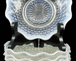919 - 7 Anchor Hocking Moonstone Opalescent Bowls (Description): Set of seven vintage Anchor Hocking Moonstone  pattern bowls featuring the distinctive  hobnail design with opalescent white ruffled  edges. The bowls display the characteristic  moonstone opalescence that transitions from clear glass centers to milky white scalloped  rims. Each bowl measures 1 1/2 inches tall by  6 inches in diameter.