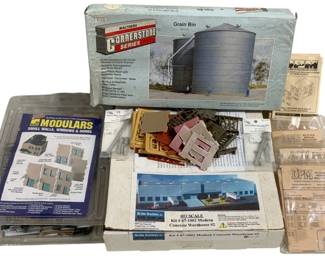1683 - Lot HO Scale Model Building Kits (Description): Lot of HO scale model building kits including  a Walthers Cornerstone Series Grain Bin,  Nu-Line Structures Kit #87-1002 Modern  Concrete Warehouse #2, Walthers Modulars  Small Walls Windows & Doors set, and several DPM (Design Preservation Models) modular wall  system kits. The lot includes both sealed  and opened kits with various architectural  components and accessories for model railroad  layouts.