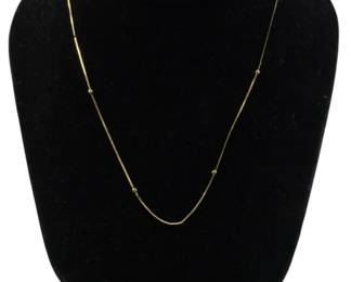 817 - 14Kt Italian Gold Necklace 0.08oz (Description): A delicate 14Kt Italian gold necklace  featuring a fine box chain with small gold  bead stations spaced evenly along its length.  This elegant station necklace has a  minimalist design perfect for everyday wear or layering. Weight: 0.08oz.