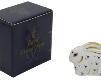 807 - Royal Crown Derby Rabbit Paperweight (Description): Royal Crown Derby Poppy Mouse paperweight  featuring a gold stopper. This charming  English fine bone china figurine displays the  classic Imari-style decoration with cobalt  blue and gold accents on a white ground. Comes with original Royal Crown Derby box.  Measures 2.5 inches.