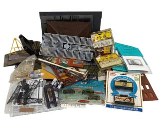 1711 - Lot HO Scale Model Train Accessories (Description): A collection of HO scale model railroad  accessories and scenery items. The lot  includes various buildings, structures, and  scenic elements suitable for model train  layouts. Featured items include a Model Power Road Scenes lighted billboard, Jordan Coupe  Cars set, Grandt Line detail parts, Woodland  Scenics figures, bridge and trestle  components, window and door detail parts,  platform grating sections, and assorted