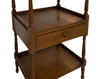 7653 - 3 Tier Table w/Drawer 38"x18"x18" (Description): Three tier table with drawer featuring turned  wood supports and gallery edges. This  traditional style piece in warm brown wood  finish includes a single drawer with round  pull knob, upper and lower shelves, and sits on turned feet. Measures 38 inches high by 18  inches wide by 18 inches deep.