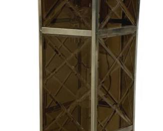 7596 - Mid-Century Modern Glass & Metal Fixture (Description): Mid-century modern hanging lantern light  fixture featuring a tall rectangular form  with smoked glass panels set within a  polished metal frame. The frame displays a  distinctive X-pattern lattice design across each glass panel on all four sides. The  fixture is equipped with metal loops at the  top and bottom for hanging. Measures 29  inches tall by 9 inches wide. Used as is electric/electronic/mechanical