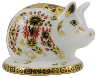 791 - Royal Crown Derby Piglet Paperweight Silver (Description): Royal Crown Derby piglet paperweight  featuring the classic Imari pattern with rich  cobalt blue, red, and gold floral decoration  on a white porcelain body. The figurine  depicts a reclining pig with gilded accents and intricate hand-painted detailing. Fitted  with a silver stopper. Measures 2 inches.