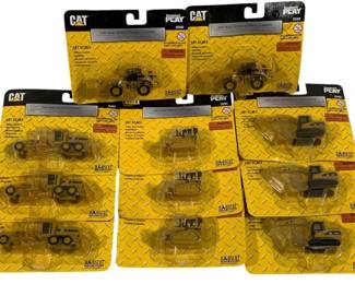 1035 - 11 Norscot 1/87 CAT Vehicles (Description): A collection of eleven Norscot 1/87 scale CAT  construction vehicles. These die-cast models  feature various Caterpillar equipment  including wheel loaders, motor graders,  track-type tractors, and hydraulic excavators. All pieces are in original  blister packaging.