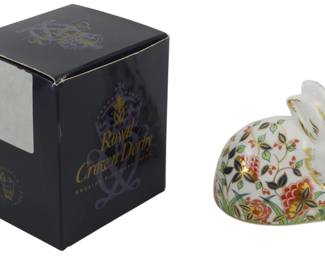 809 - Royal Crown Derby Porcelain Meadow Rabbit (Description): Royal Crown Derby porcelain rabbit  paperweight in the Imari style. The figurine  features a crouching rabbit decorated with a  floral pattern in traditional red, blue,  green, and gold colorway. Comes with original Royal Crown Derby presentation box.