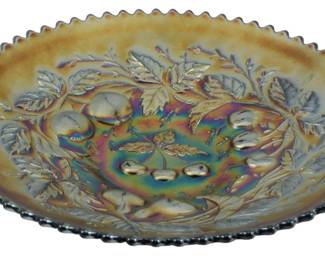 711 - Vtg Northwood Amethyst Three Fruits Carnival (Description): Vintage Northwood Amethyst Three Fruits  Carnival Glass Dish featuring a rich  iridescent surface with brilliant  multicolored reflections in purple, gold,  blue, and green hues. The pressed glass design showcases a central medallion  surrounded by raised fruit motifs including  cherries, pears, and apples with detailed  foliage. The dish has a distinctive sawtooth  or crimped edge typical of carnival glass