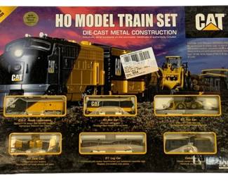 1071 - CAT HO Model Train Set Die-Cast Ltd Ed (Description): Limited edition HO scale model train set  featuring CAT (Caterpillar) branding. This  die-cast metal construction set includes  multiple cars and a locomotive. The set comes  with a certificate of authenticity and each locomotive is individually serial numbered. A  collectible item for model train enthusiasts  and Caterpillar fans alike.